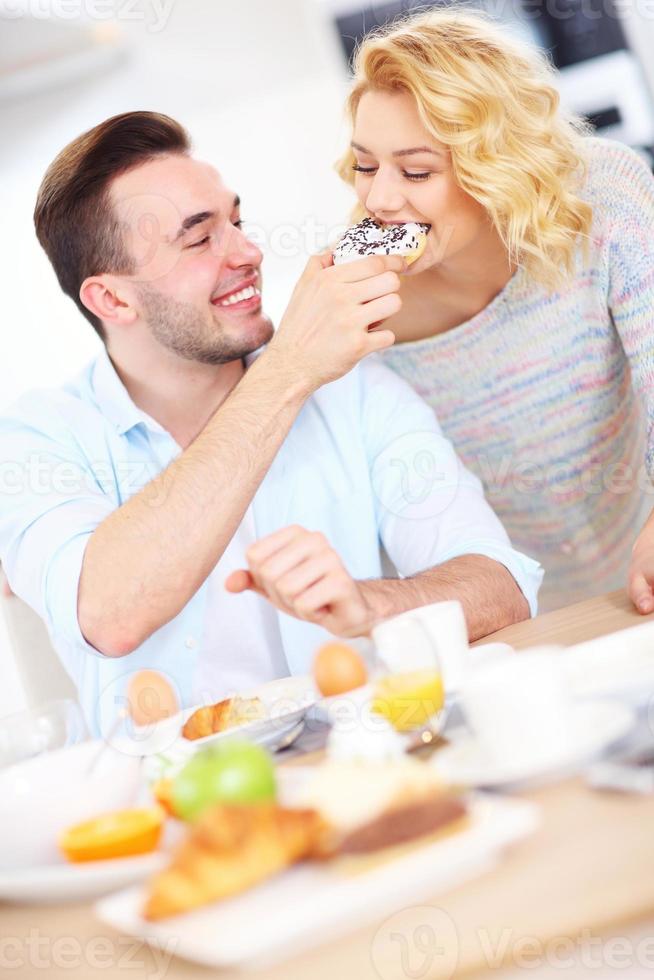 Happy couple eating breakfast photo