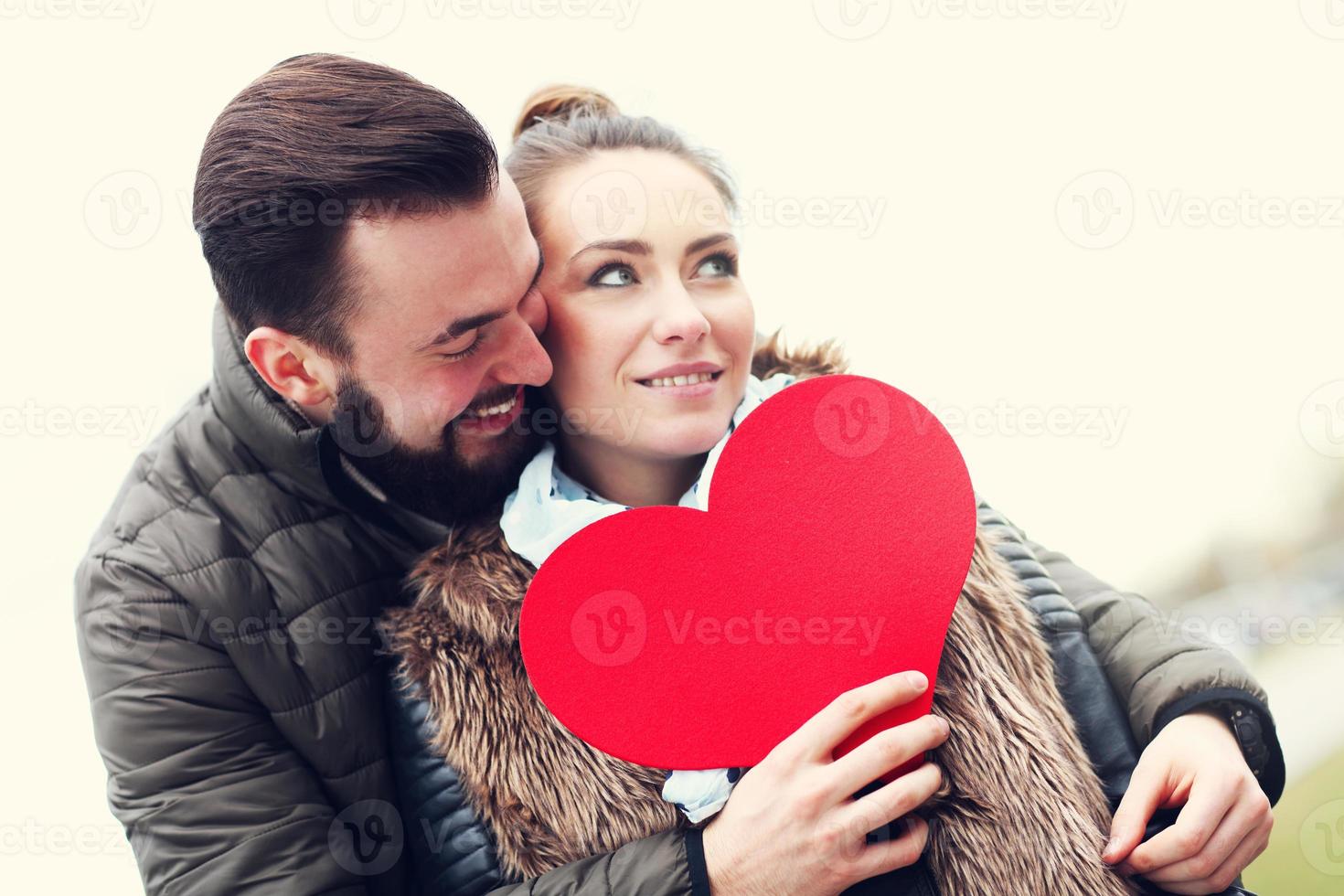 Romantic couple holding heart photo