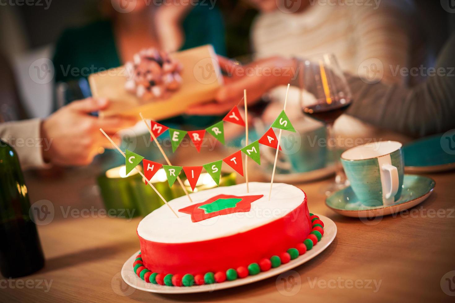 Midsection of group of friends with presents celebrating Christmas at home photo