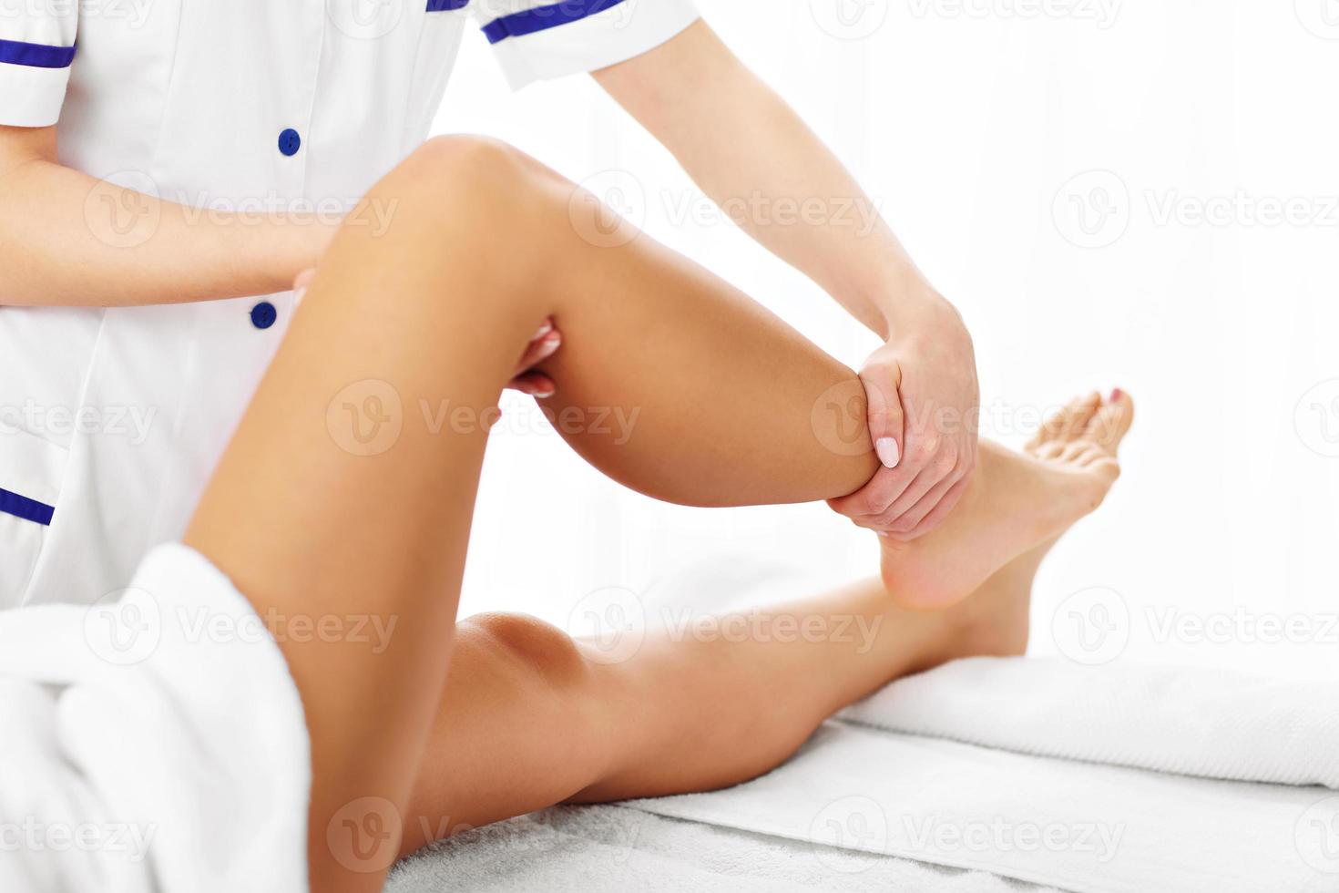 A picture of woman having leg therapy photo