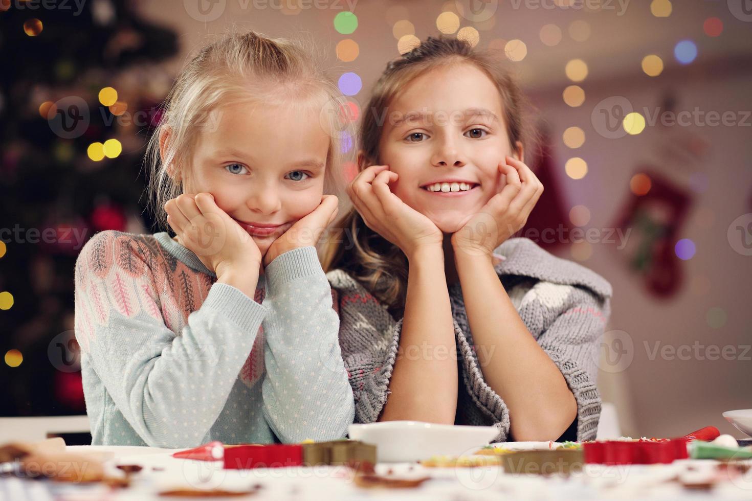 Happy little sisters preparing Christmas biscuits photo