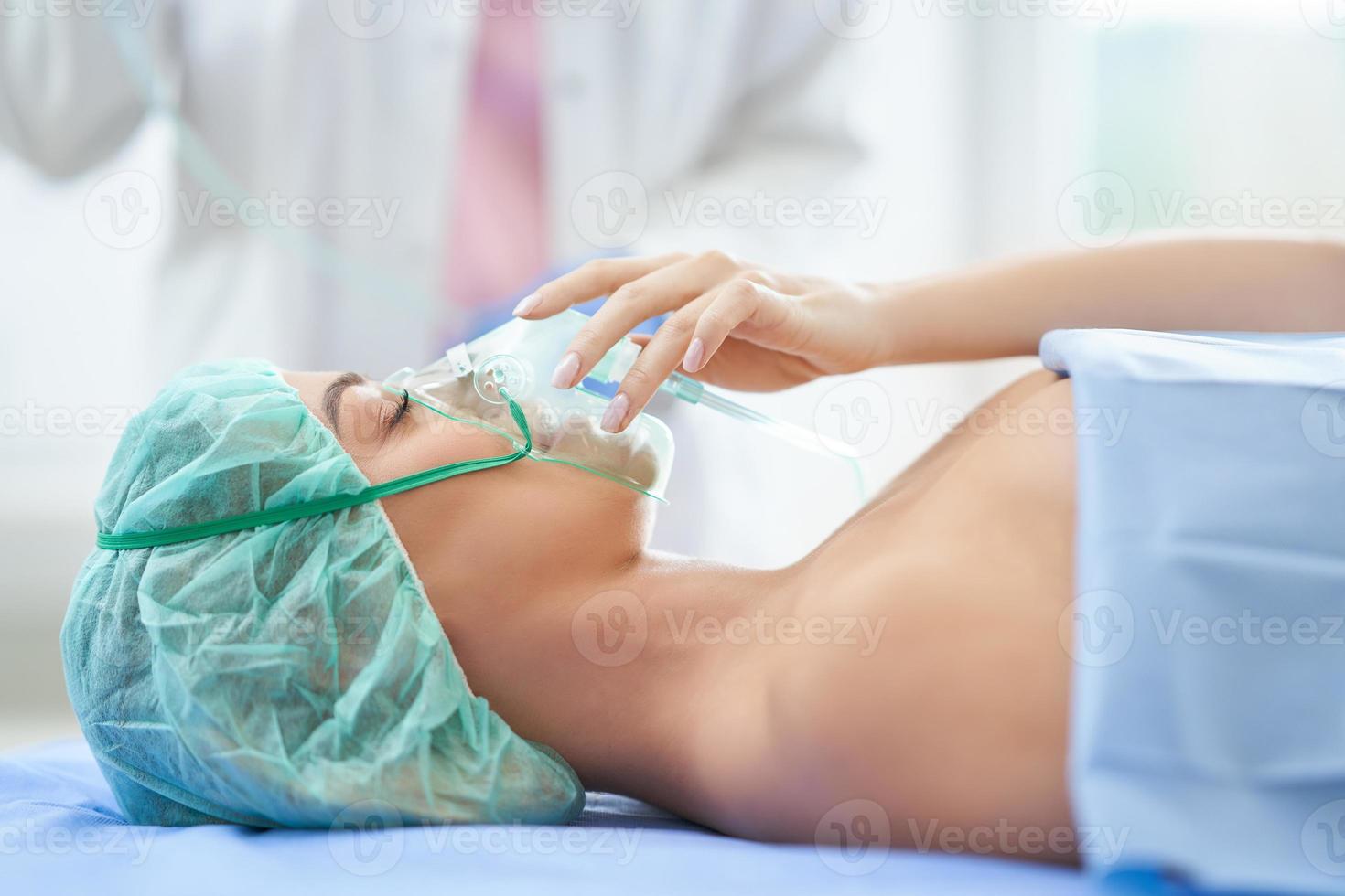 Nurse gives respiratory therapy to a patient recovering in the hospital photo
