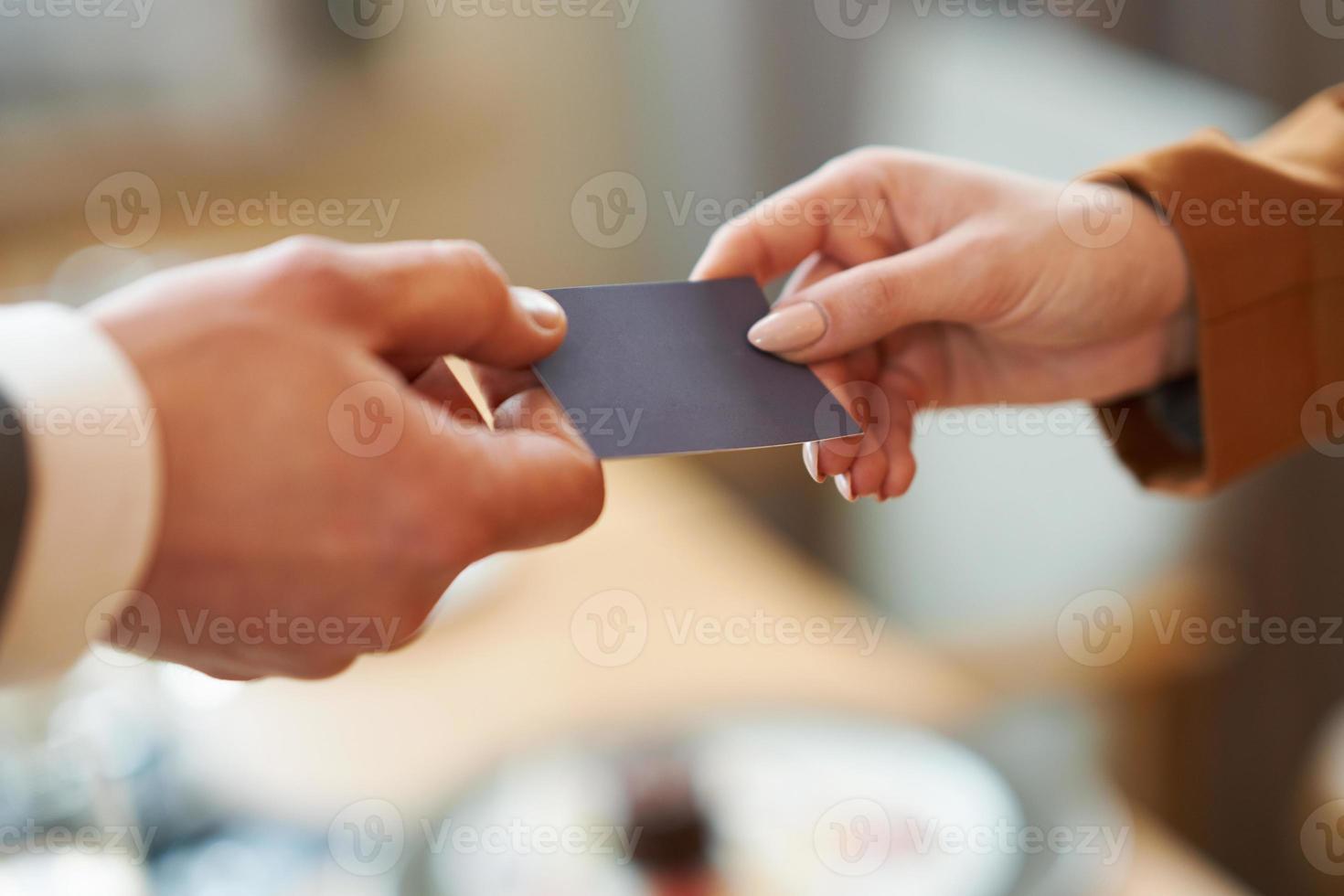 retrato de primer plano de dos ejecutivos de negocios exitosos intercambiando tarjetas de negocios foto