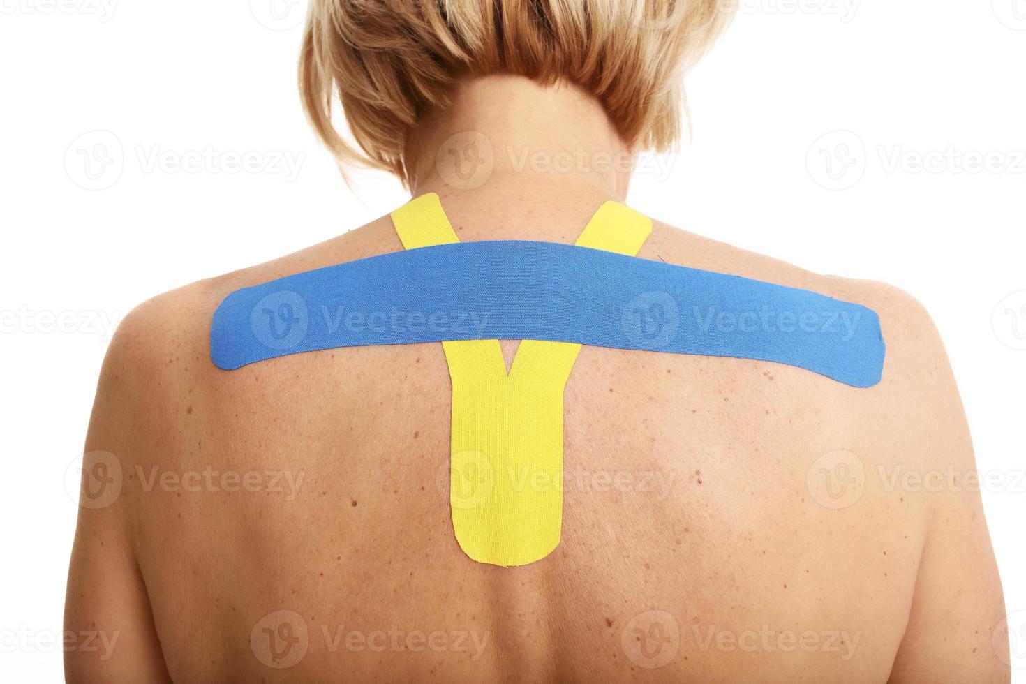 Picture showing special physio tape put on injured back over white background photo