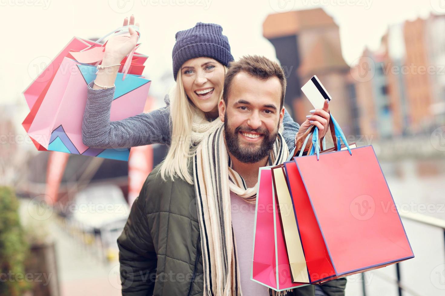 Happy couple shopping in the city photo