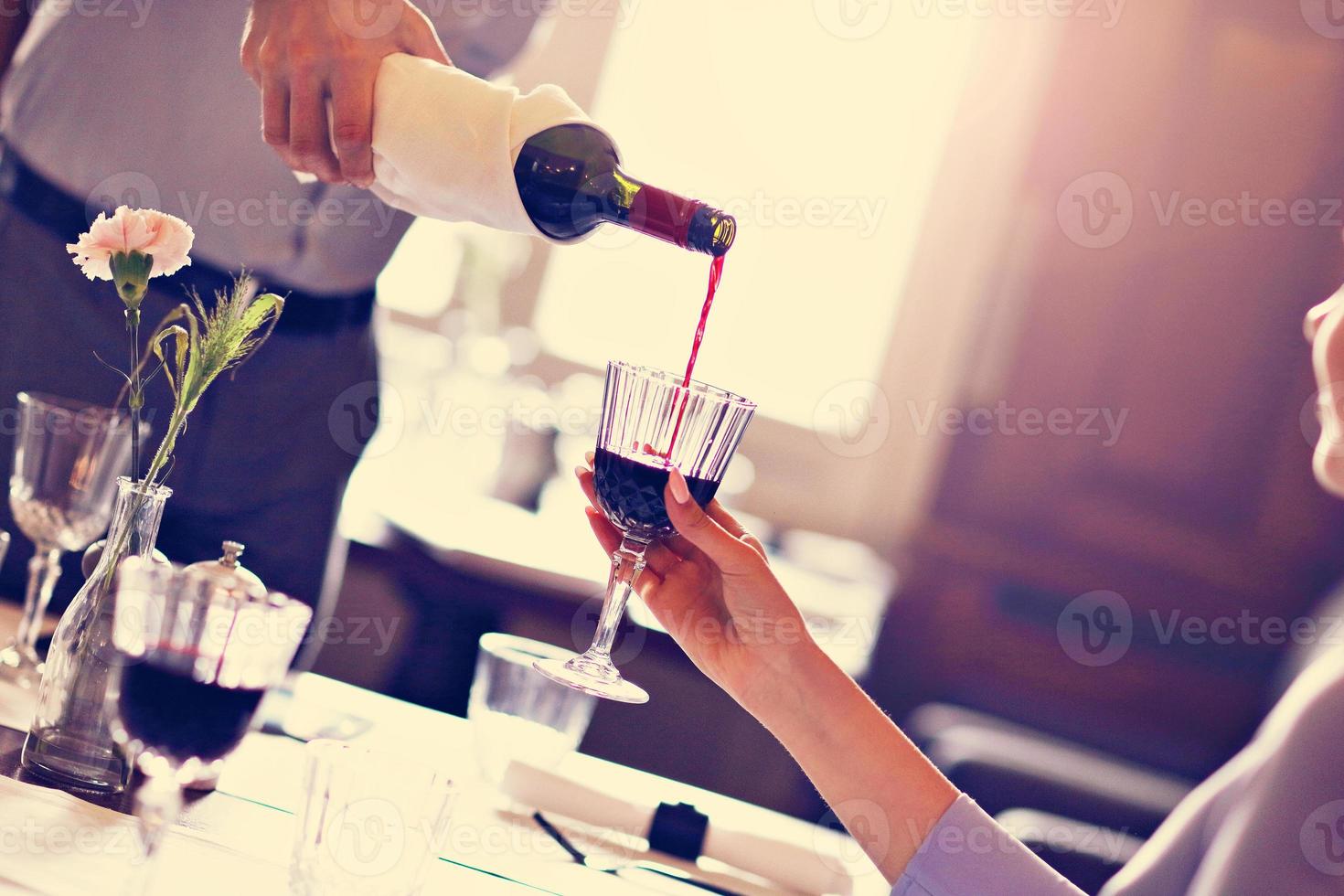 Romantic couple dating in restaurant being served by waiter photo