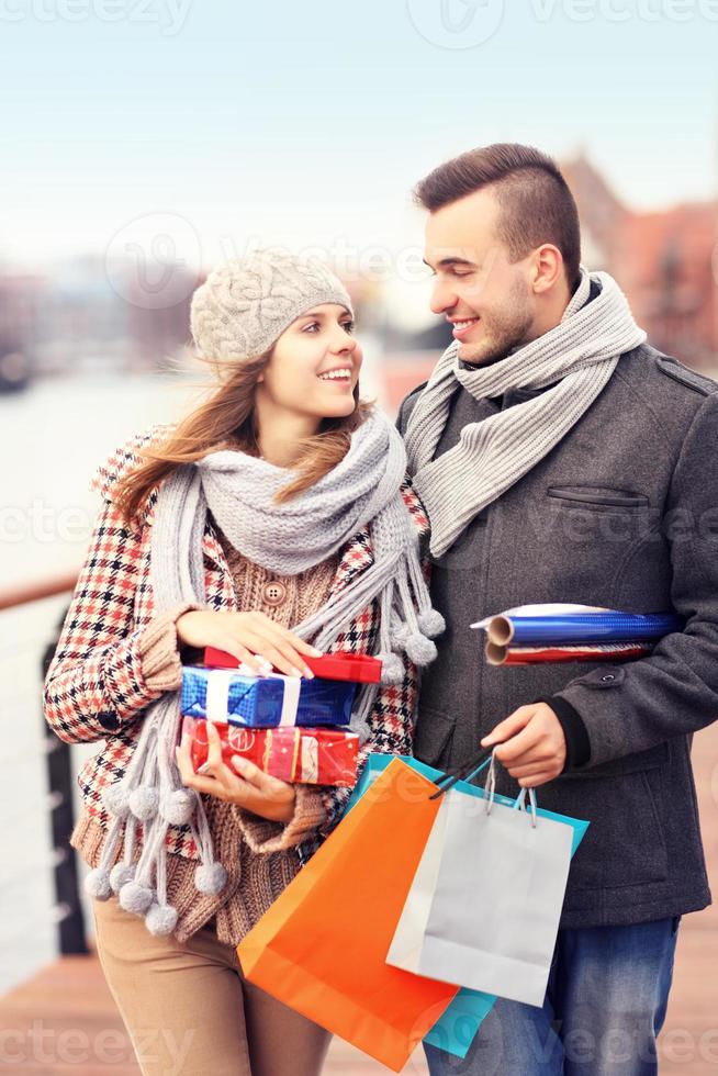 Cheerful young people doing Christmas shopping photo