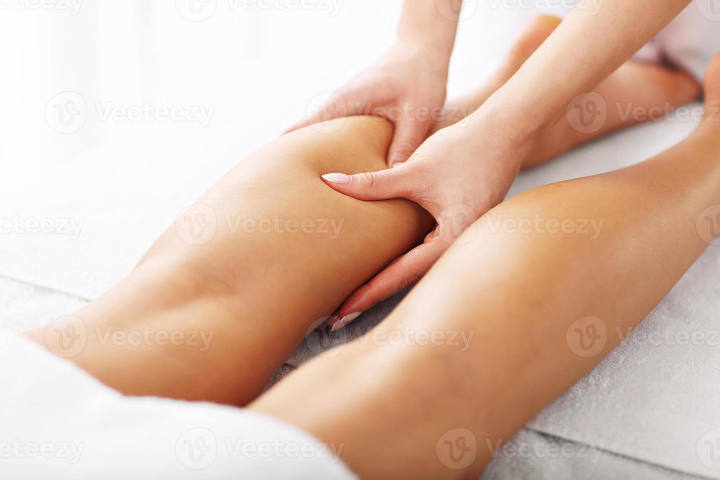 A picture of woman having leg therapy photo