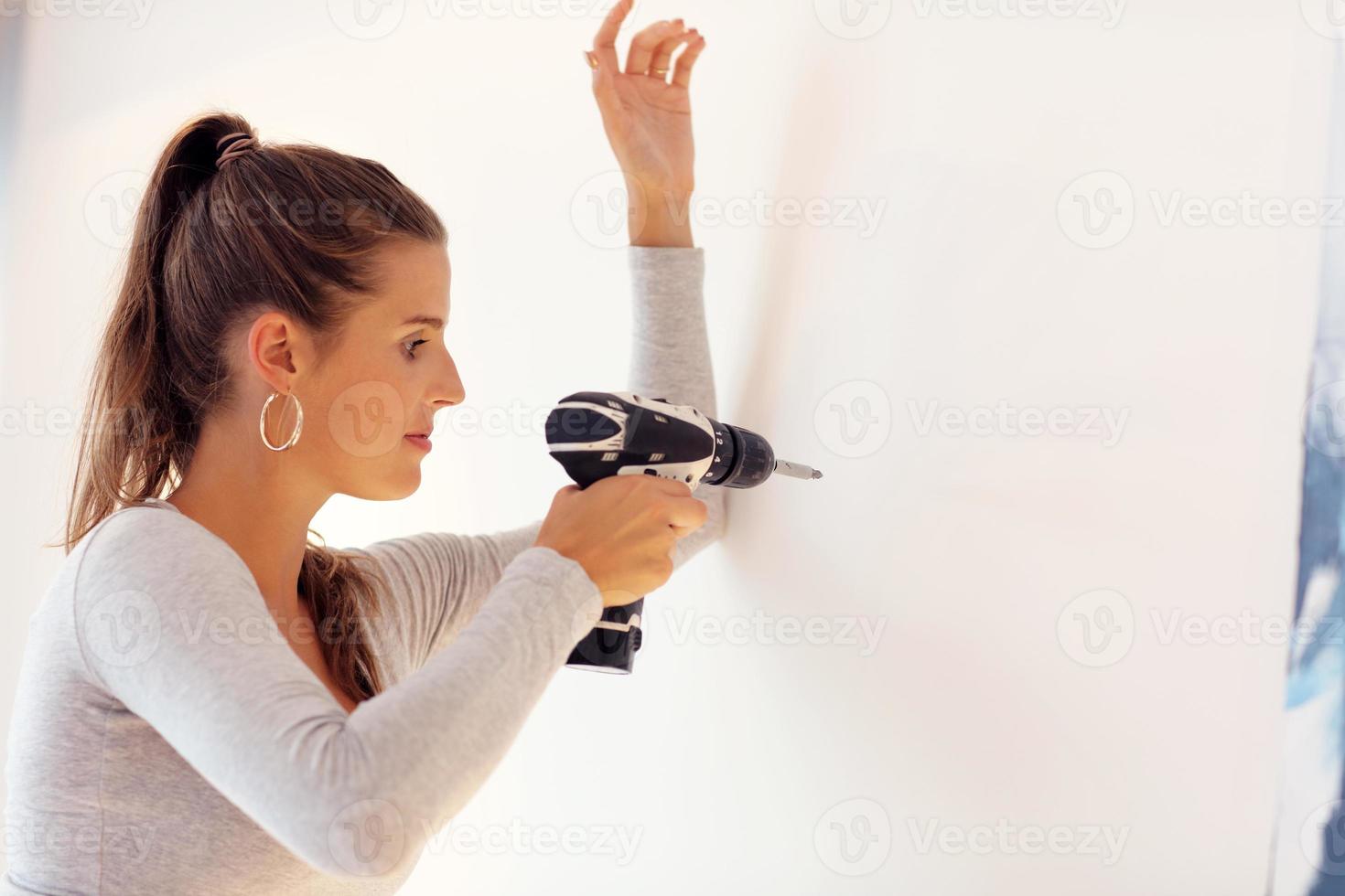 Mature woman doing home improvements photo