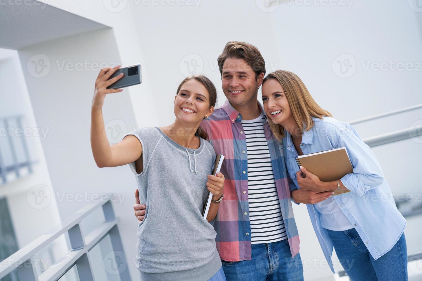 Group of students using smartphone in the campus photo
