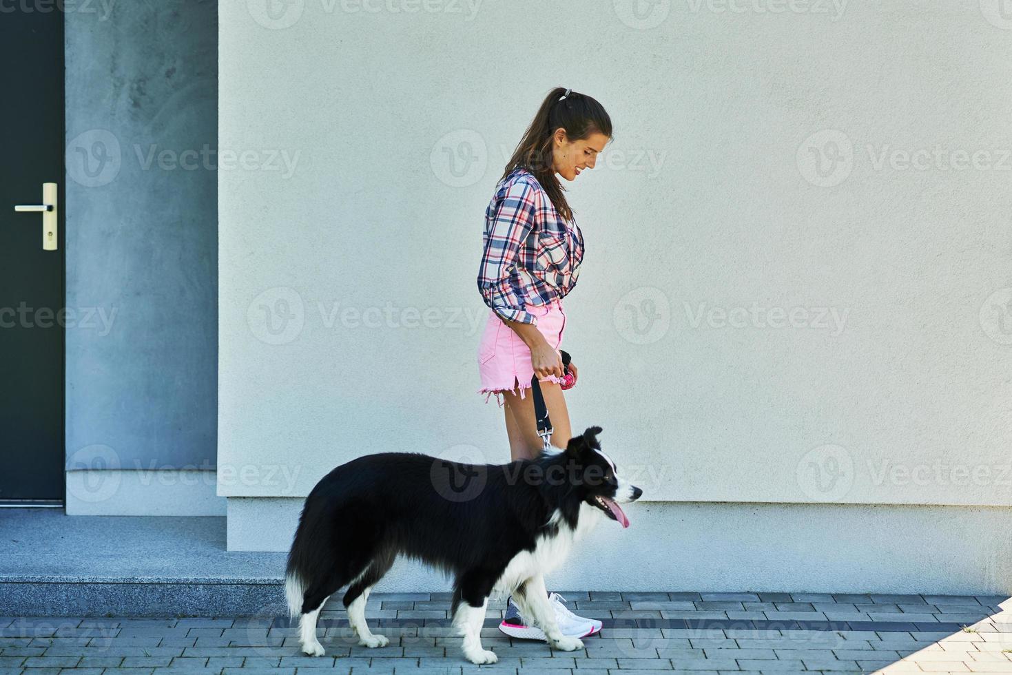 Portrait of happy female walking her dog at leisure photo