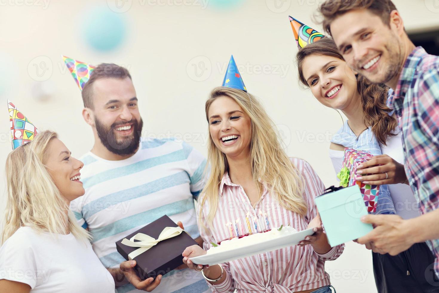 Group of friends having fun at birthday party photo