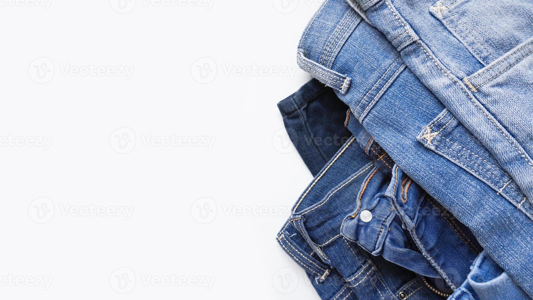 Denim jeans of different shades on white background banner with copy space photo