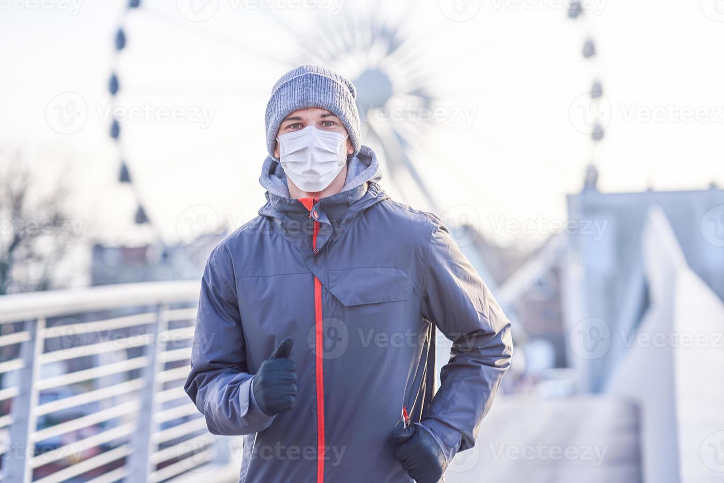 Adult man jogging in the city in masks during lockdown photo