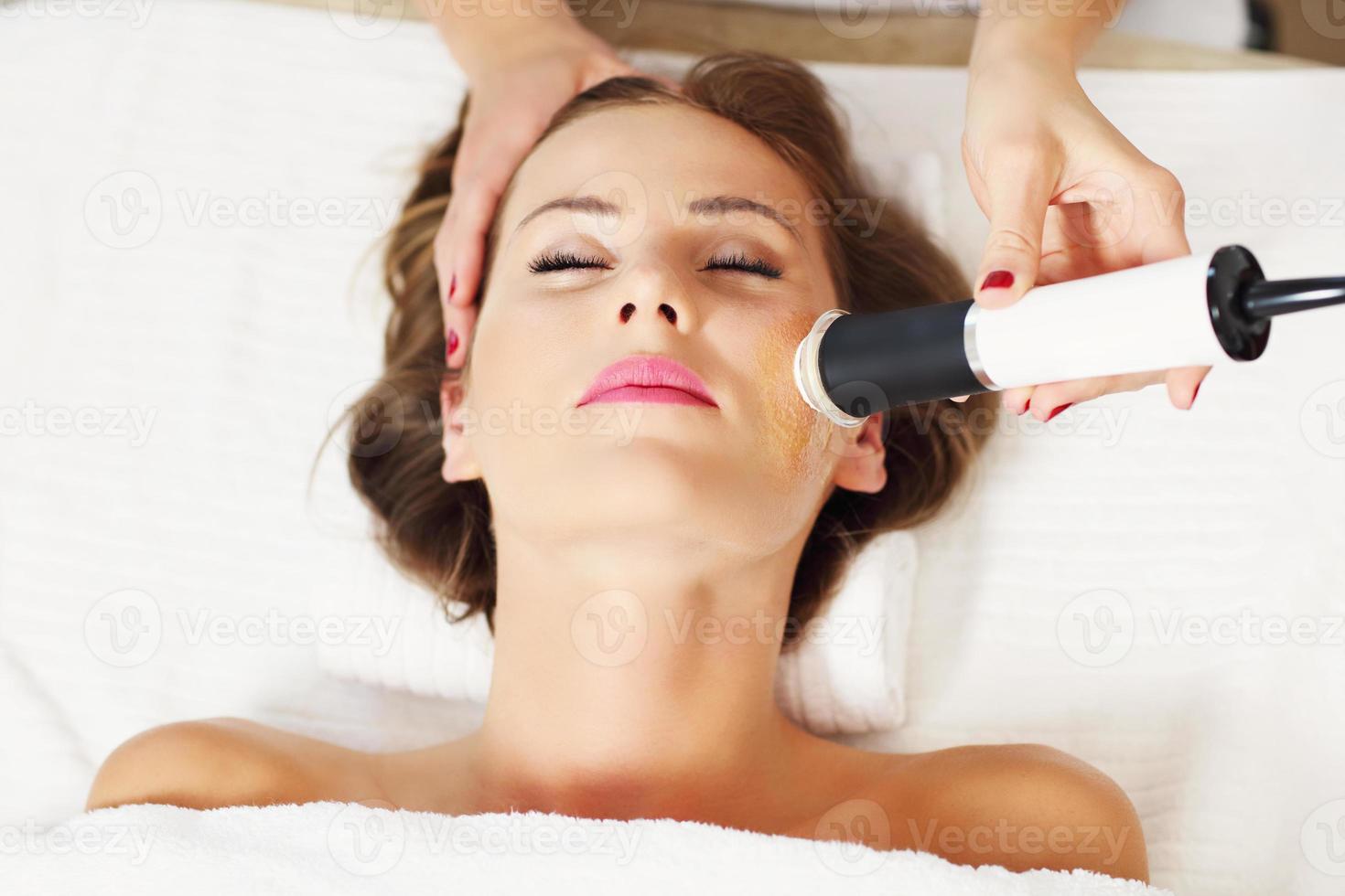 mujer con peeling facial en salón de belleza foto