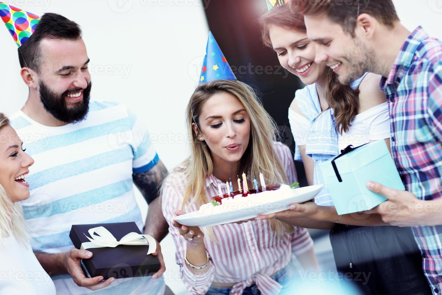 Group of friends having fun at birthday party photo