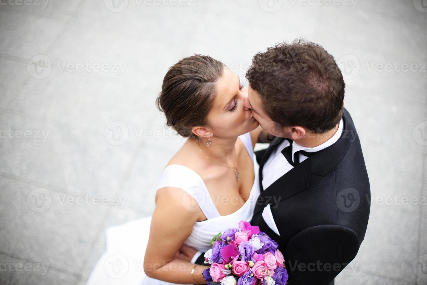 Young married couple kiss photo