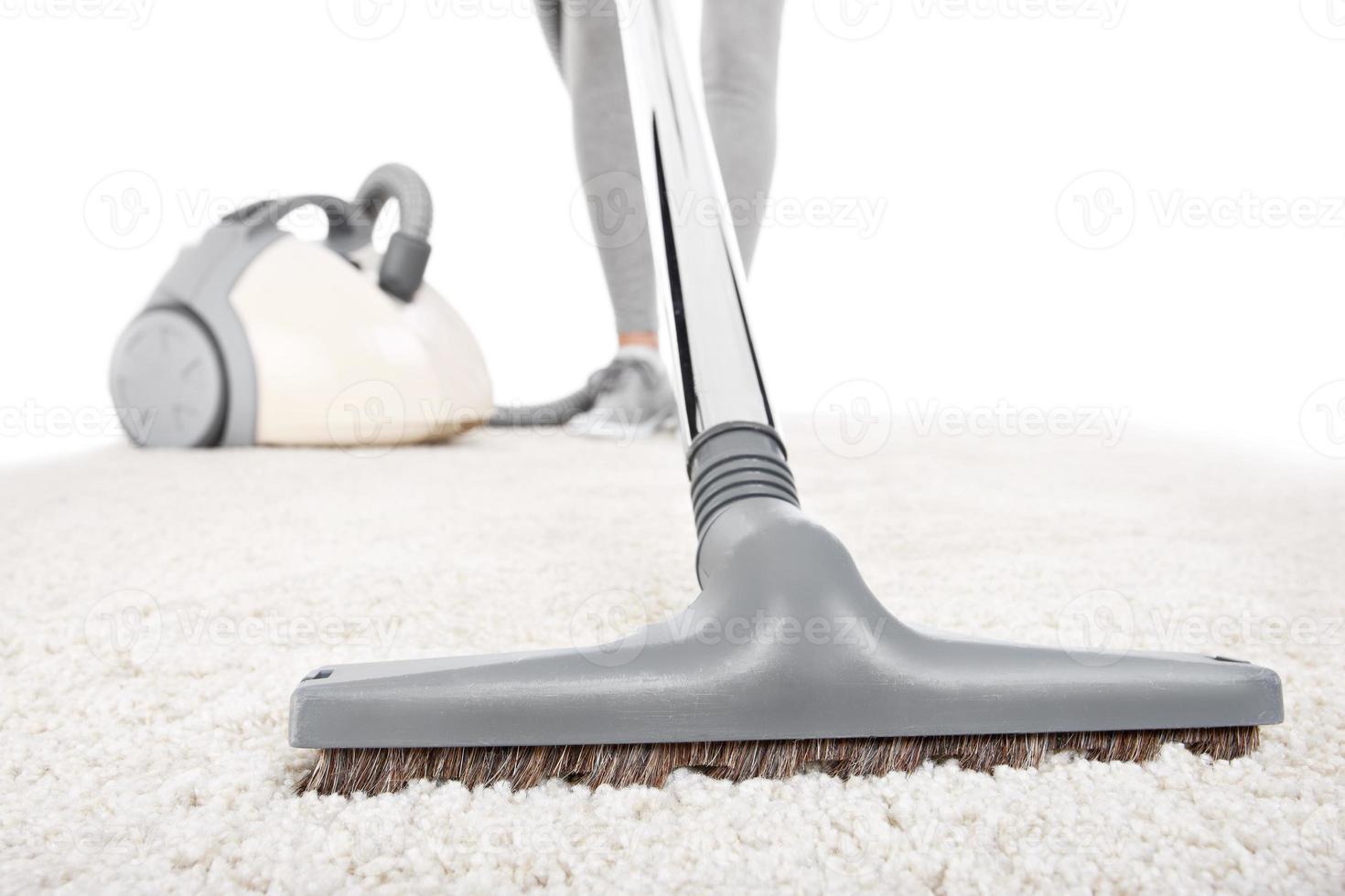 Vacuuming carpet close-up photo