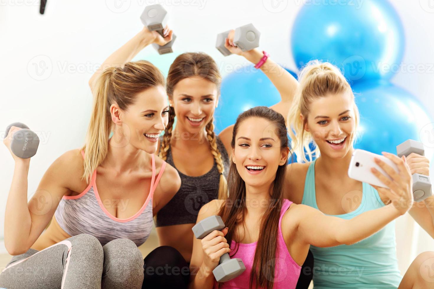 Young women group taking selfie at the gym after workout photo