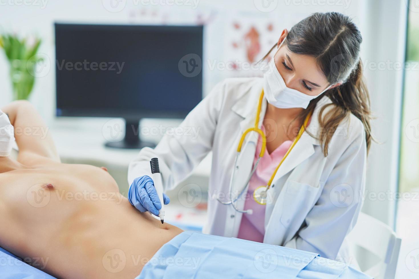 Plastic surgeon consulting a female patient photo