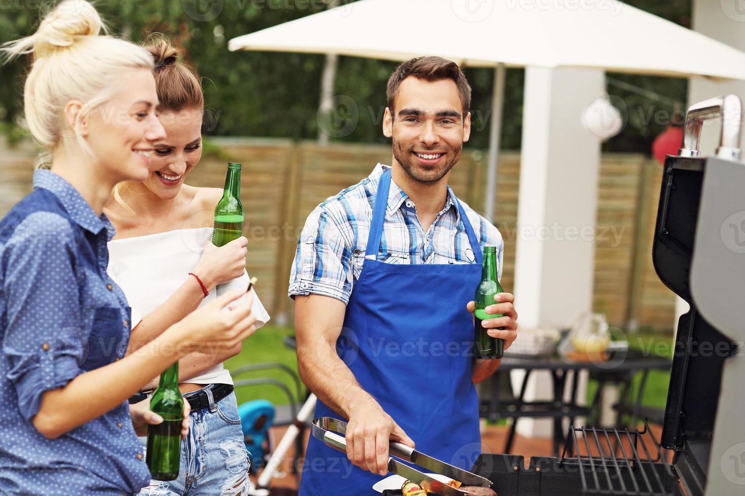 Group of friends having barbecue party photo