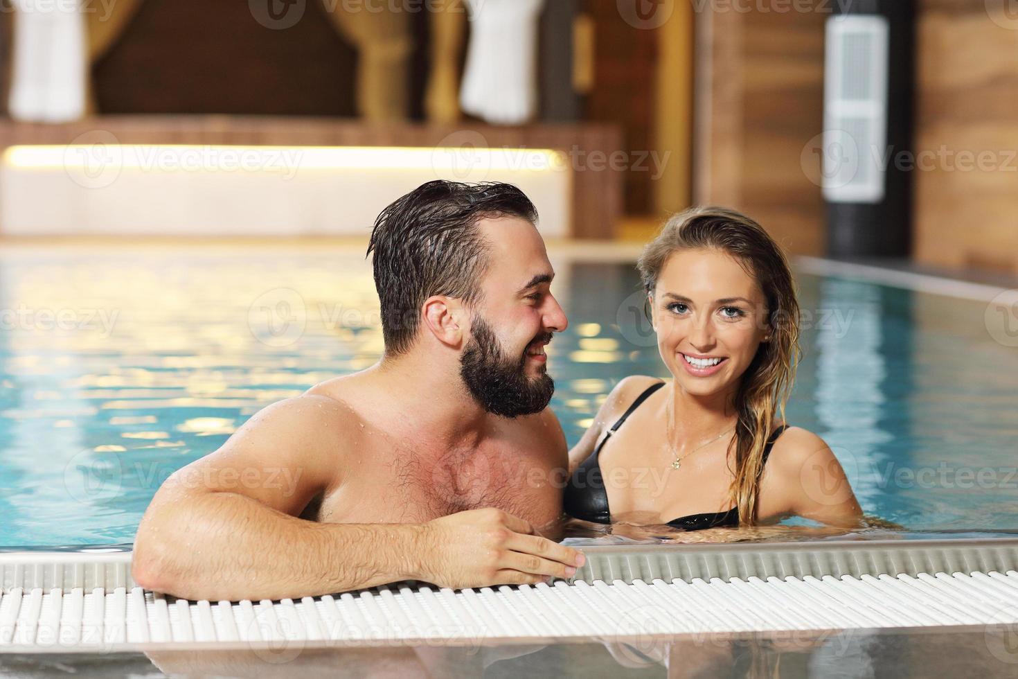 Happy couple relaxing in pool spa photo