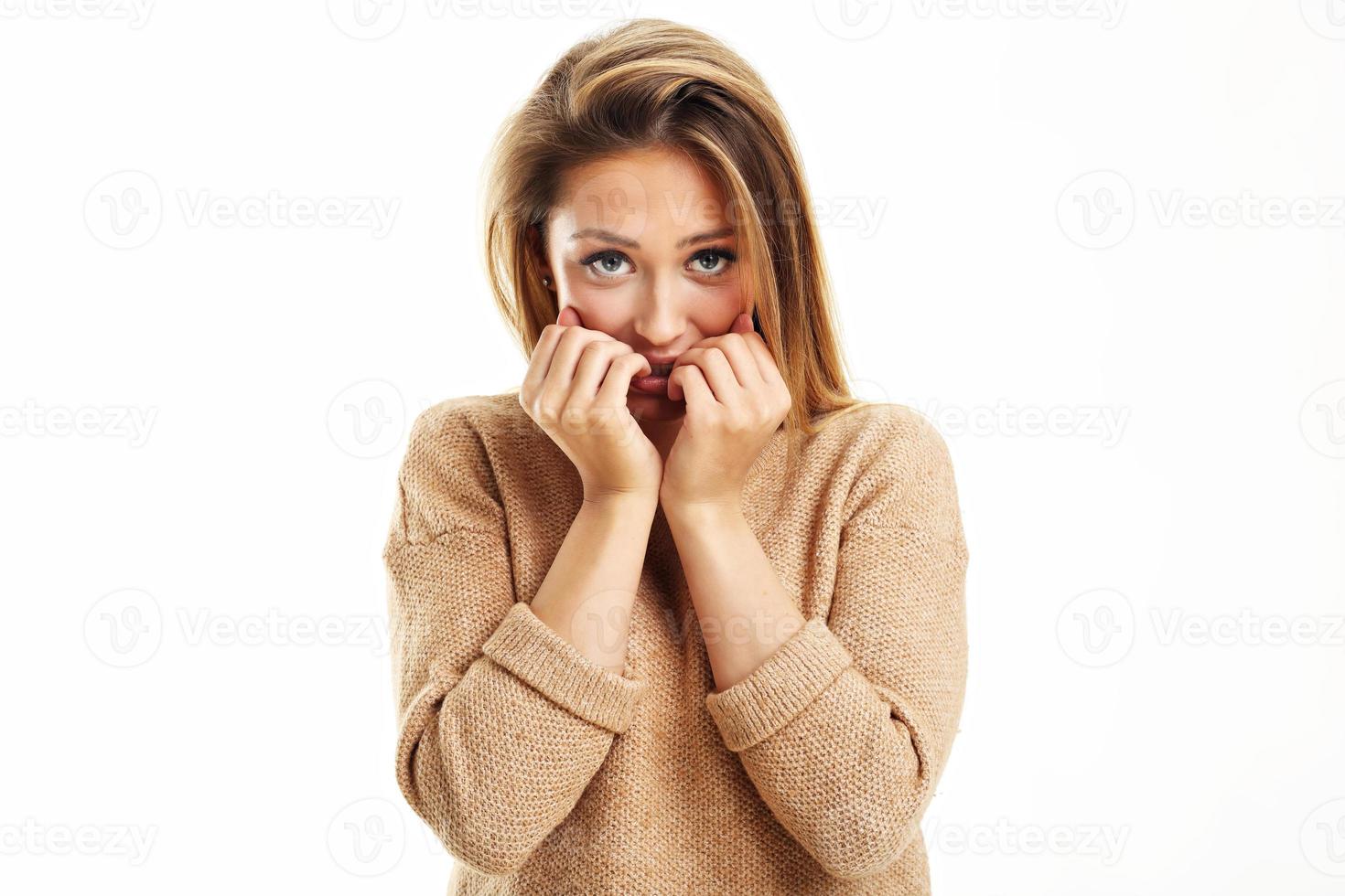 Afraid woman looking at camera isolated on a white background photo