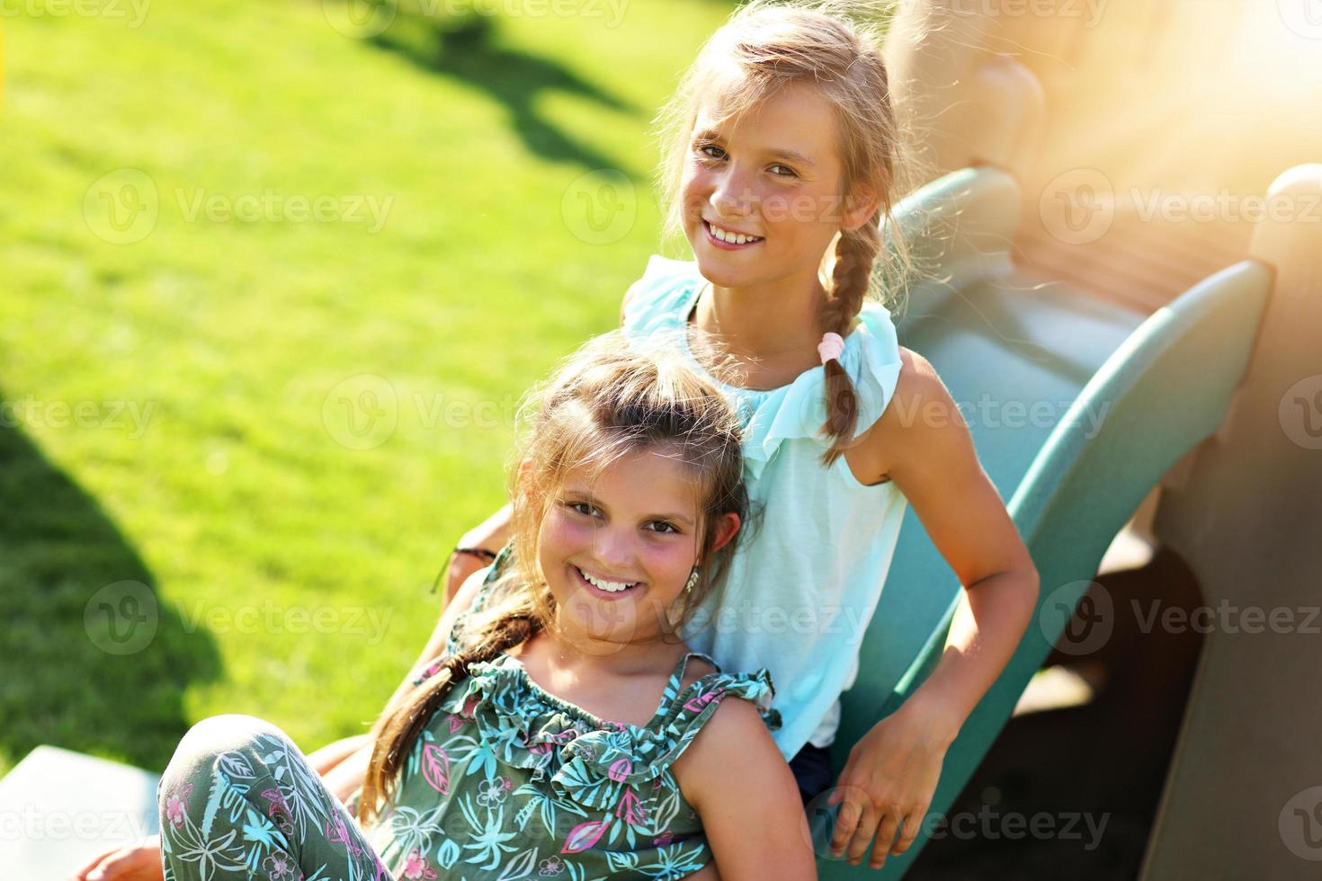 Joyful children having fun on playground photo