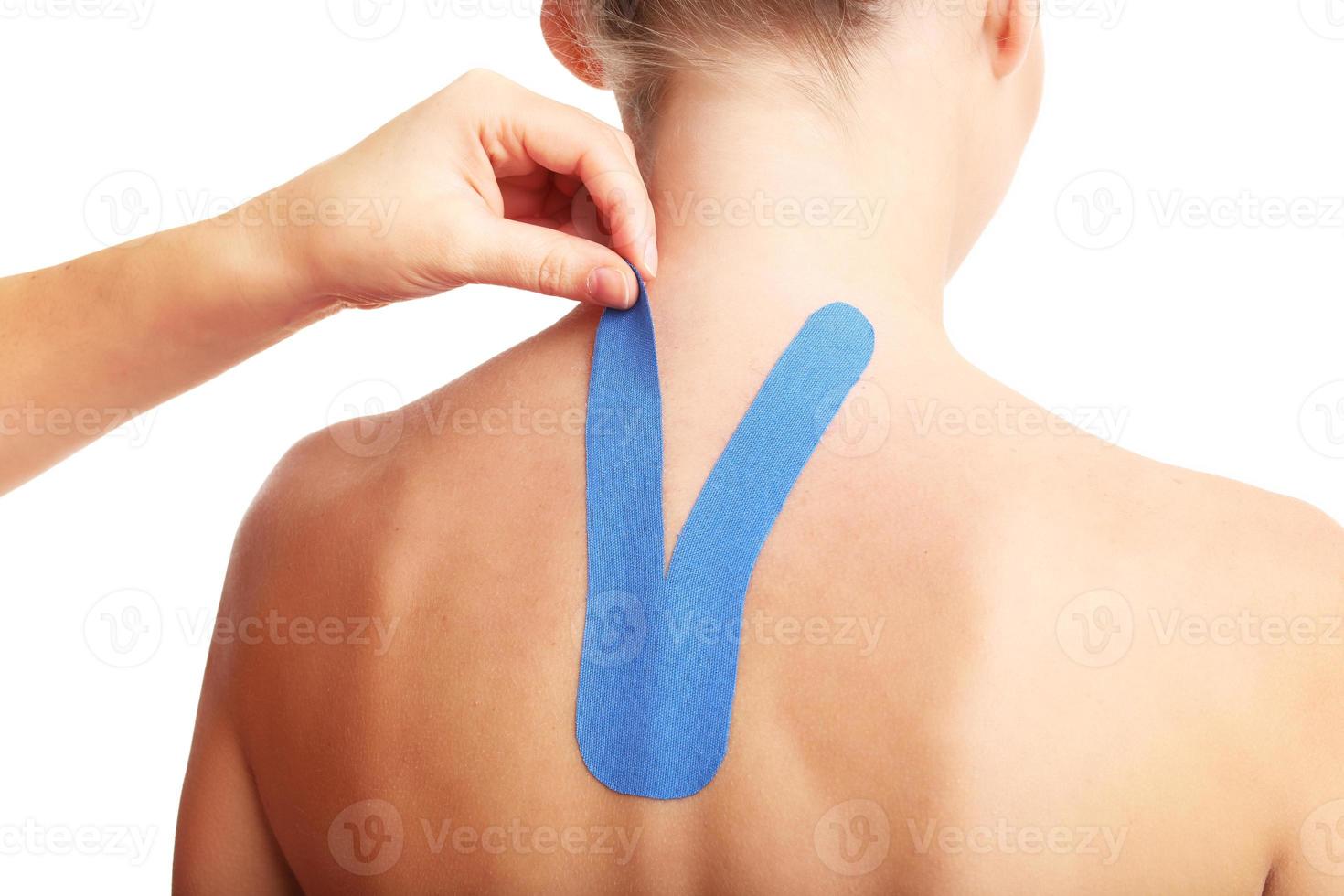 Picture showing special physio tape put on injured back over white background photo