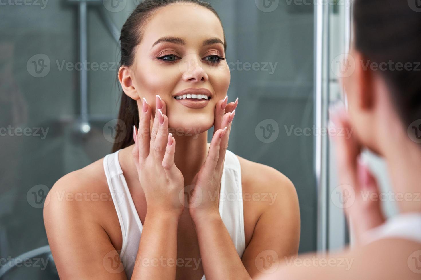 Woman looking on reflection in the mirror after shower 15813381 Stock