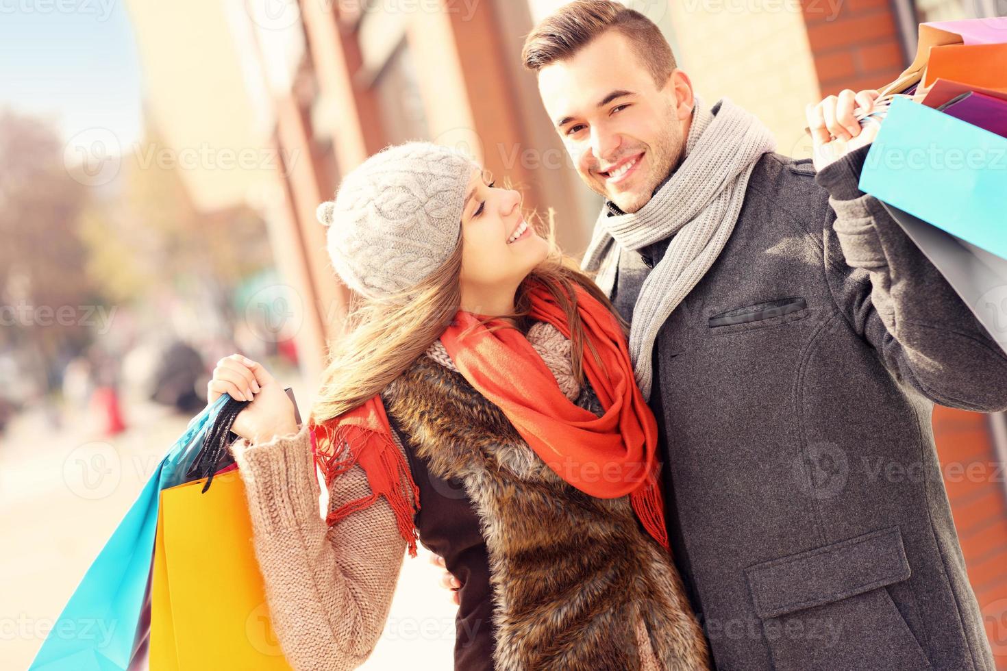 Happy couple shopping in the city photo