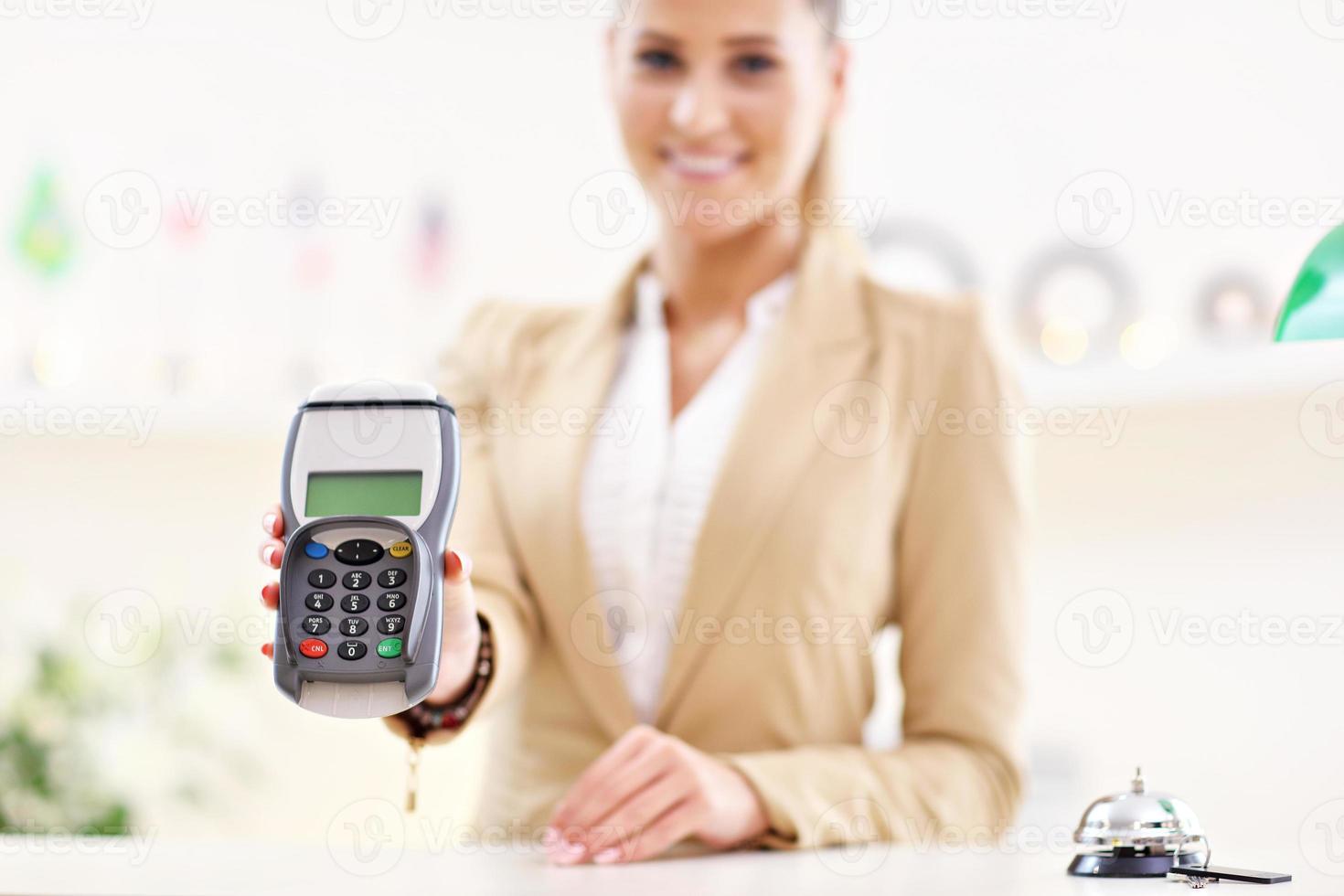 Happy receptionist working in hotel photo