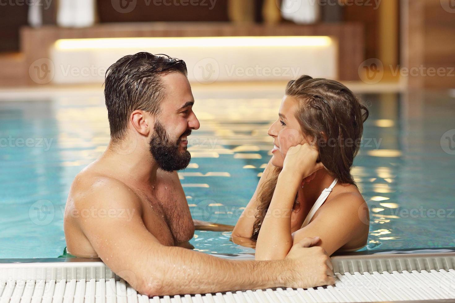 Happy couple relaxing in pool spa photo