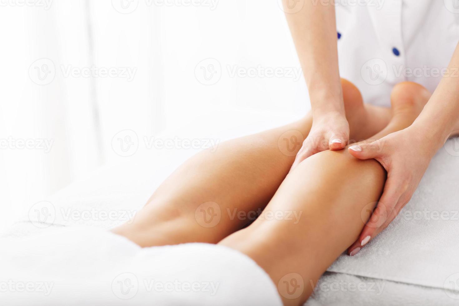 A picture of woman having leg therapy photo