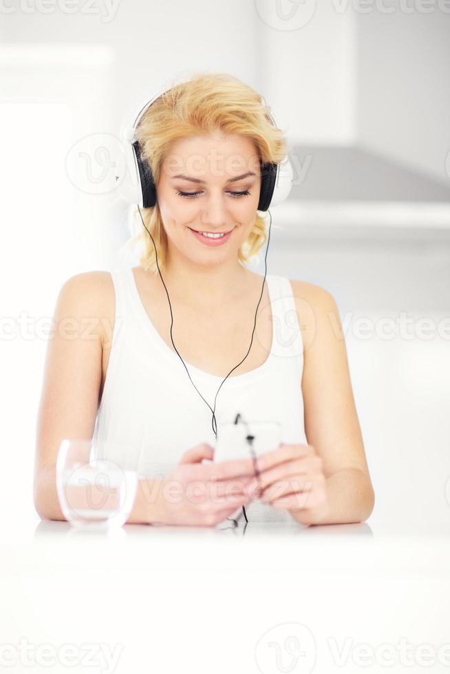 Young woman listening to music at home photo