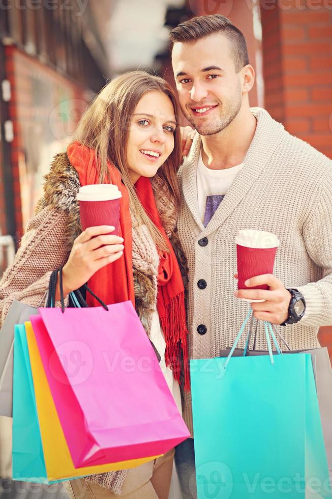 Happy couple shopping in the city photo