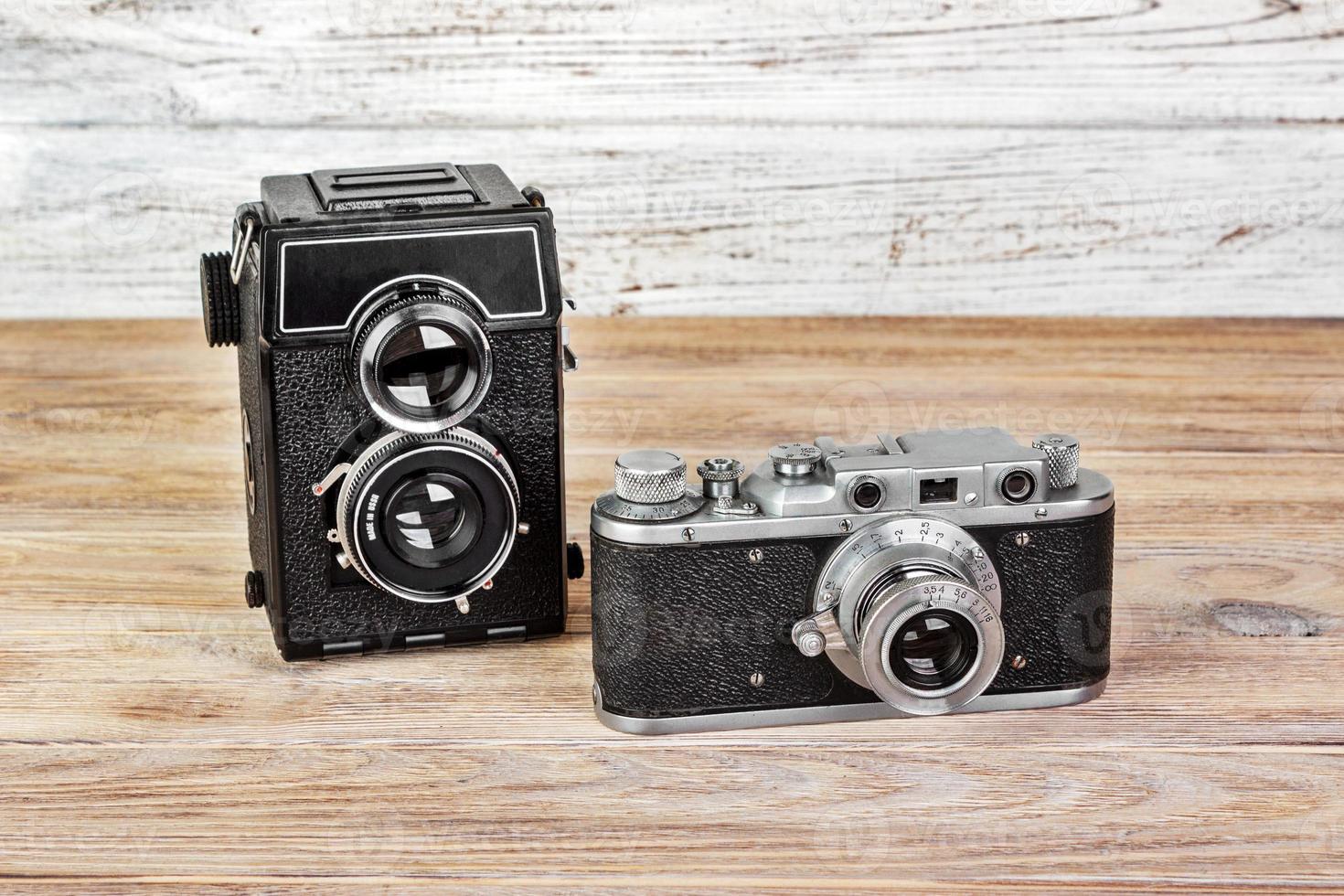 old camera with two lenses and Retro camera on a wooden background photo