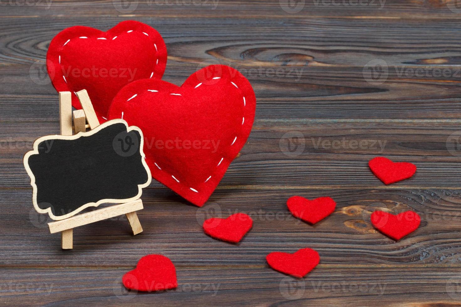 Blackboard on wooden background with red heart. Copy space photo