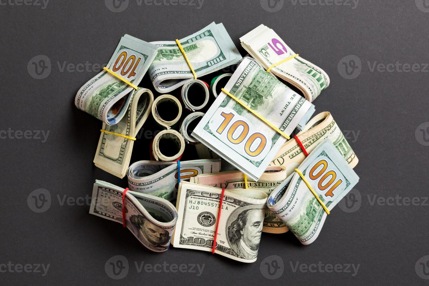 Stacks of one hundred dollars banknotes close-up on colored background business concept top view with copy space photo