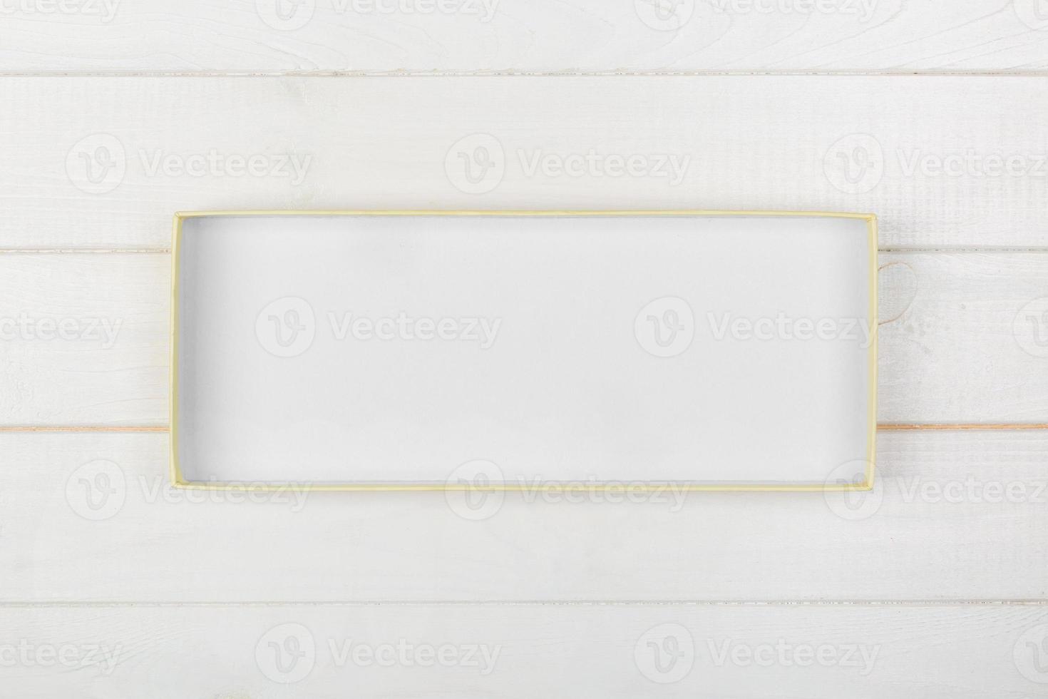 White rectangular empty open box, top view on white wooden background. top view photo