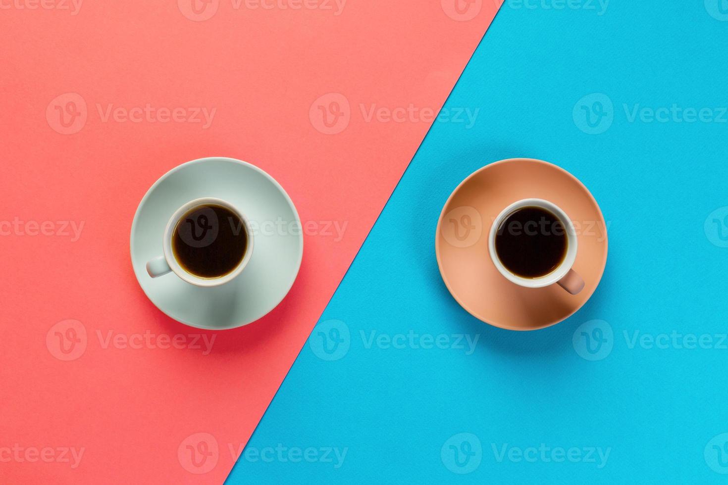 Blue and brown cup of coffee on a colorful orange and blue background. top view with copy space. morning concept photo