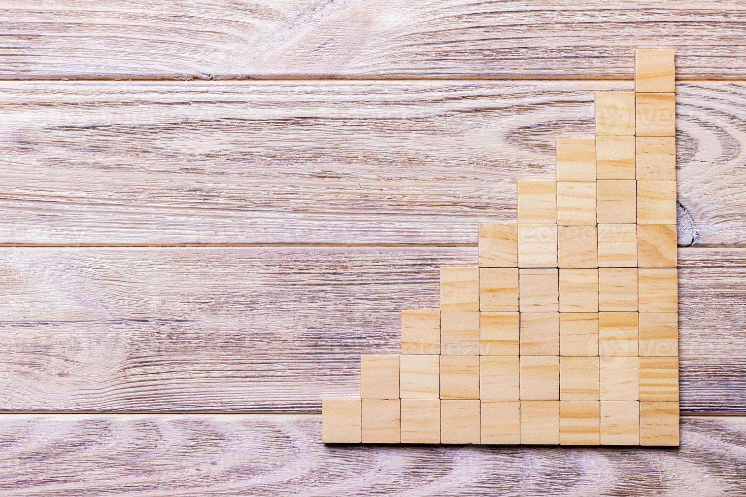 A wooden blocks cube over black wooden textured background with copy space for add word text title. Concept or conceptual Wood block stair or nine steps. Cubic photo