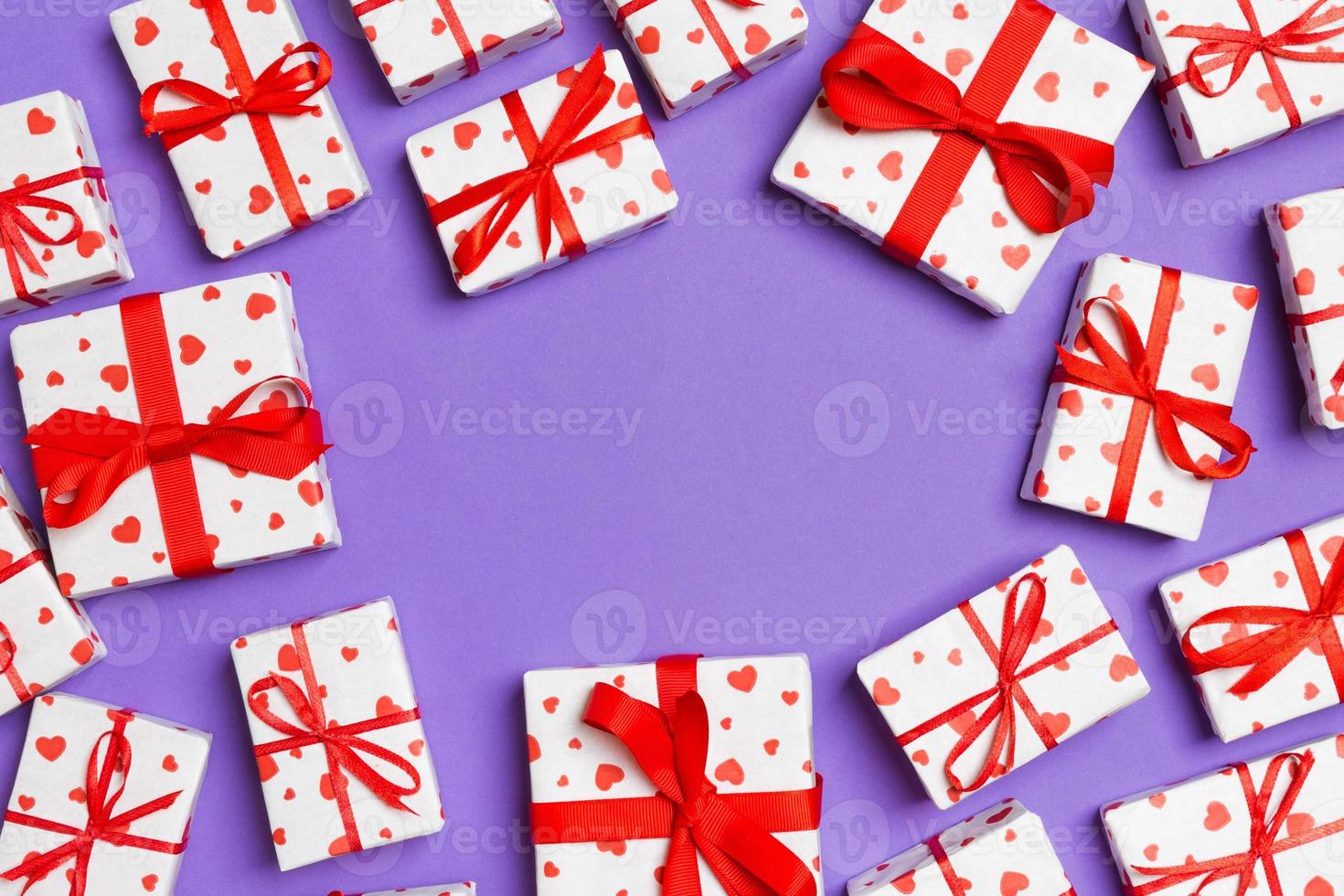 Top view of gift boxes with red hearts on colorful background. St Valentine's day concept with copy space photo