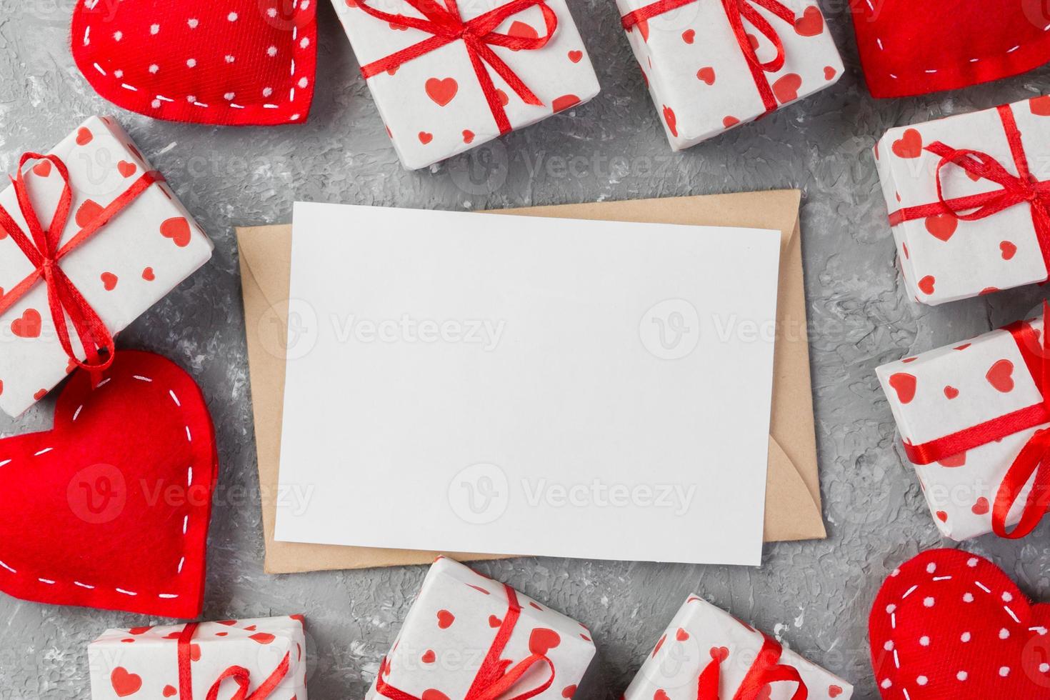 Envelope Mail with Red Heart and gift box over grey cement Background. Valentine Day Card, Love or Wedding Greeting Concept photo