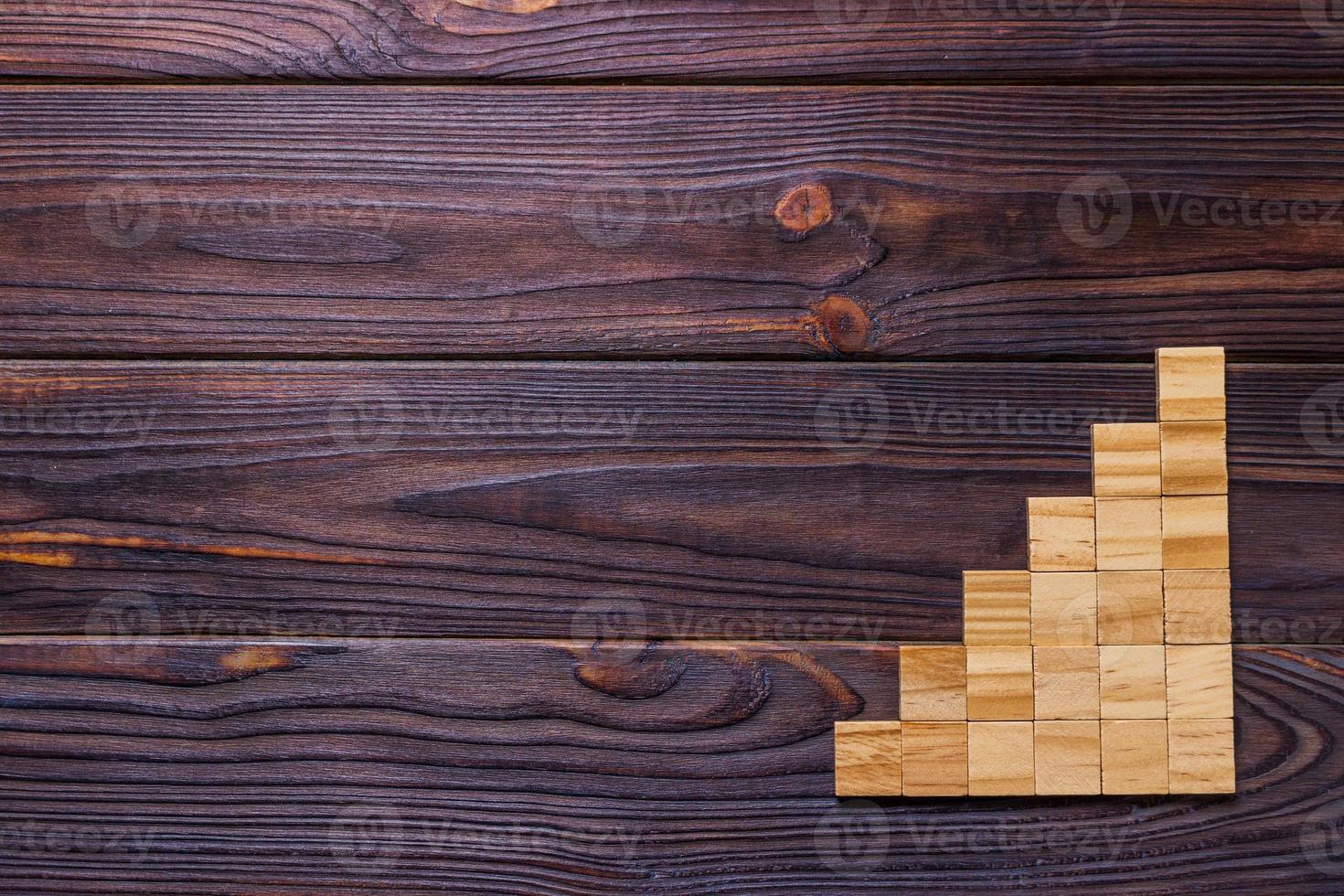 A wooden blocks cube over black wooden textured background with copy space for add word text title. Concept or conceptual Wood block stair or six steps. Cubic photo