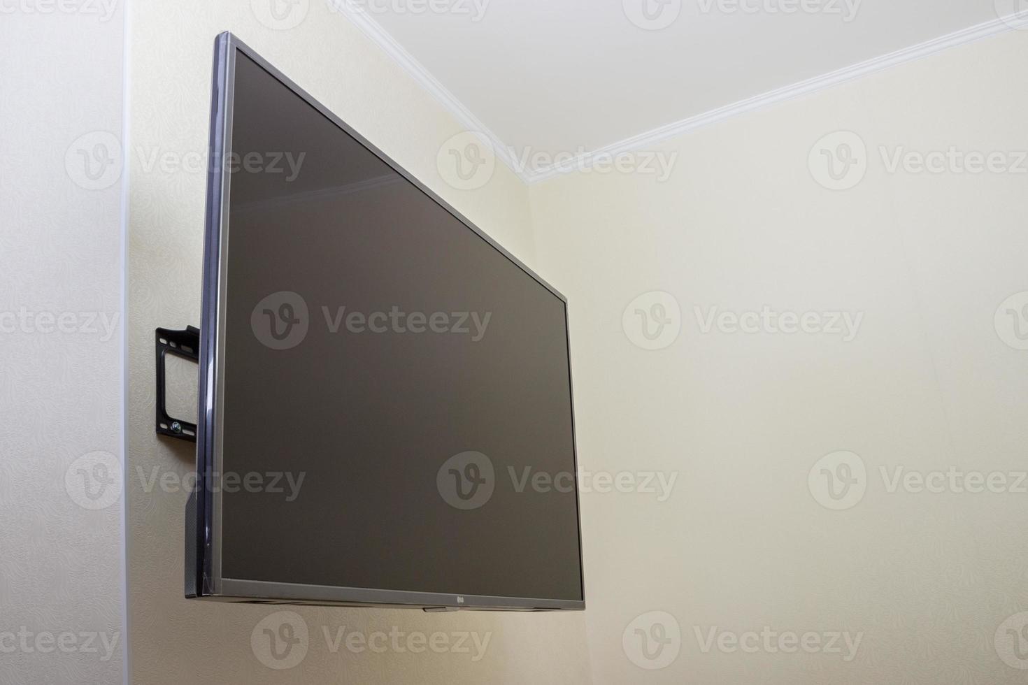 Black LED tv television screen mockup mock up, blank on white wall background photo