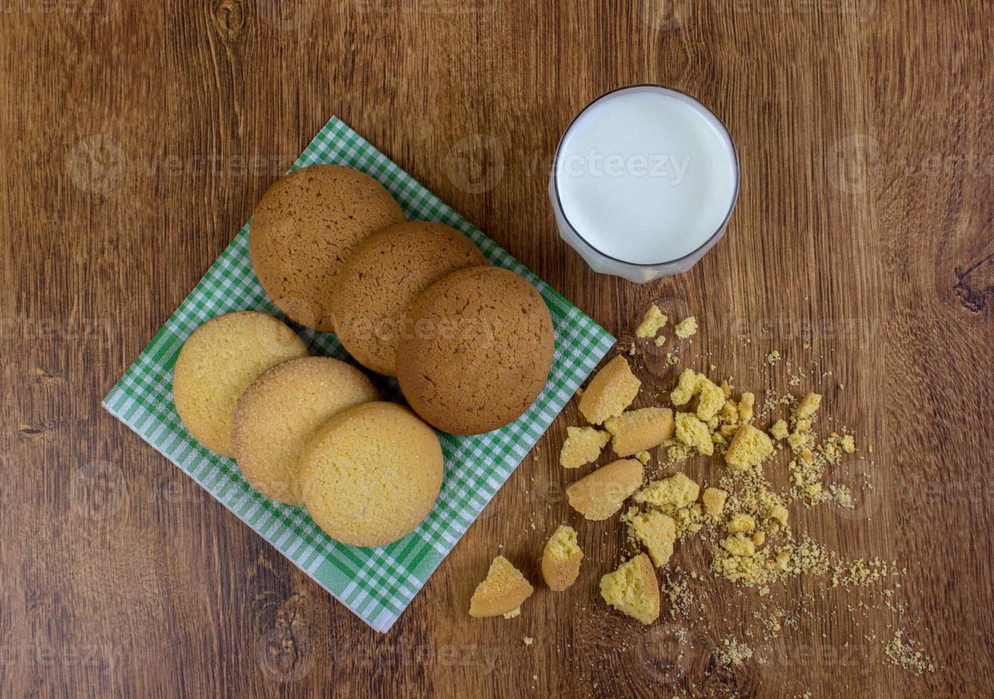 food, junk-food, culinary, baking and eating concept - close up oatmeal cookies and milk glass photo