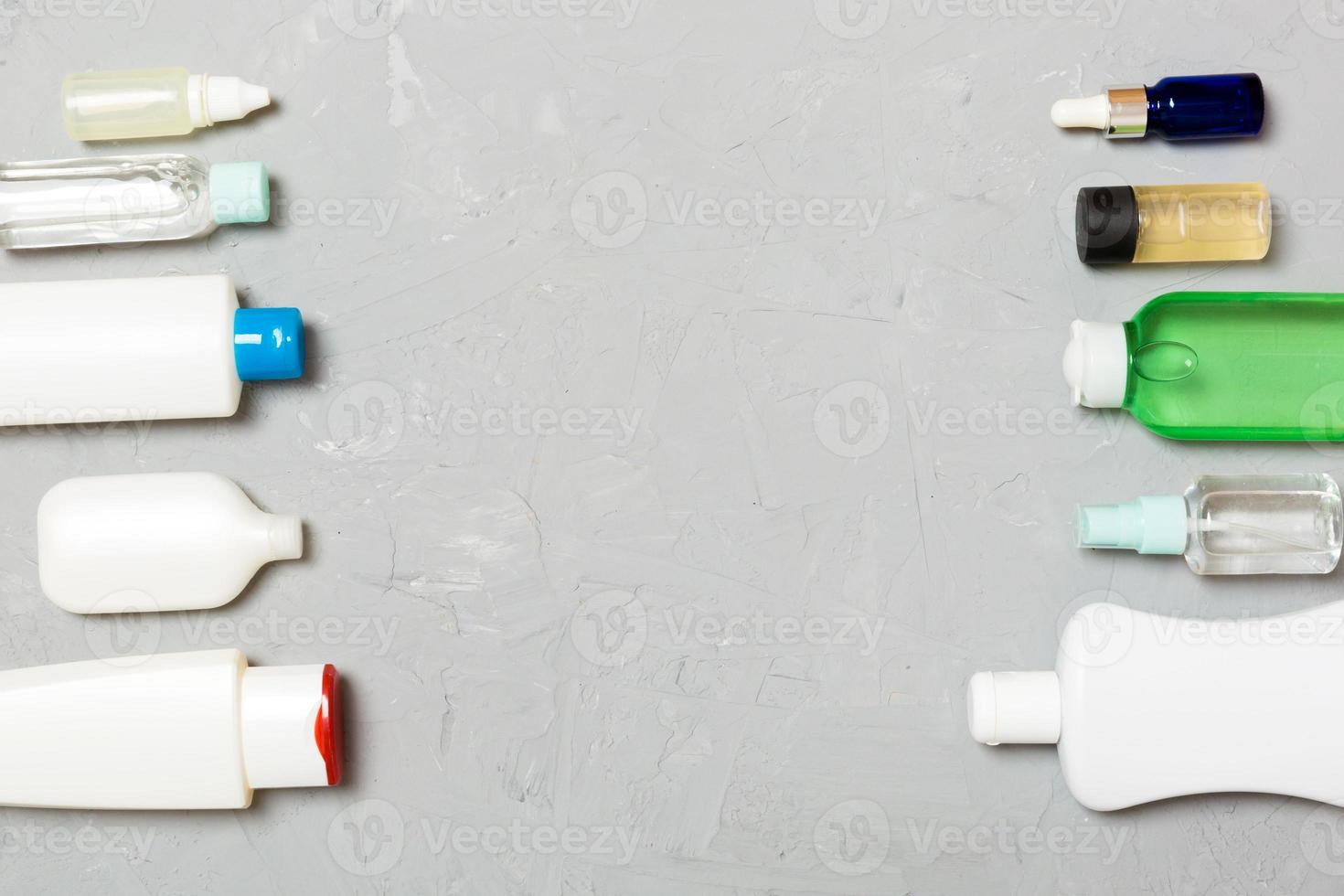 Frame of plastic bodycare bottle Flat lay composition with cosmetic products on green background empty space for you design. Set of White Cosmetic containers, top view with copy space photo