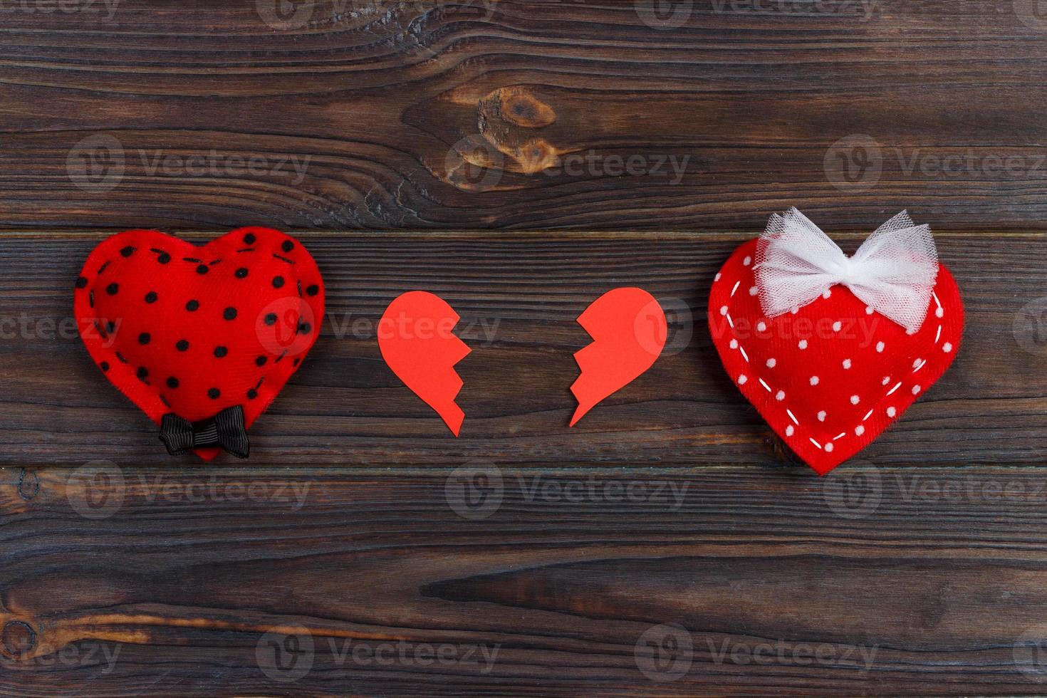 Broken heart on rustic wooden table background photo