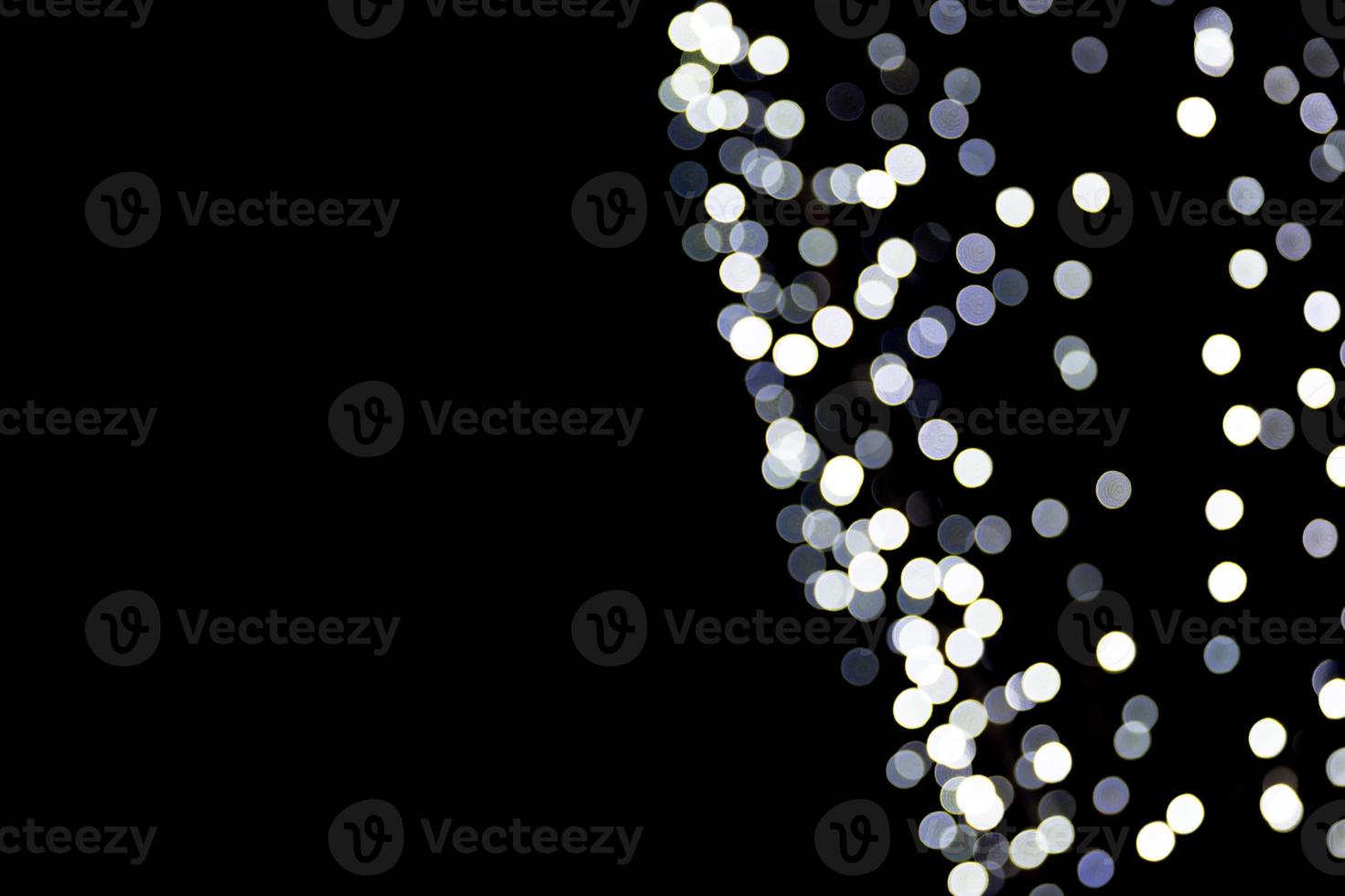 Abstract bokeh of white city lights on black background. defocused and blurred many round light photo